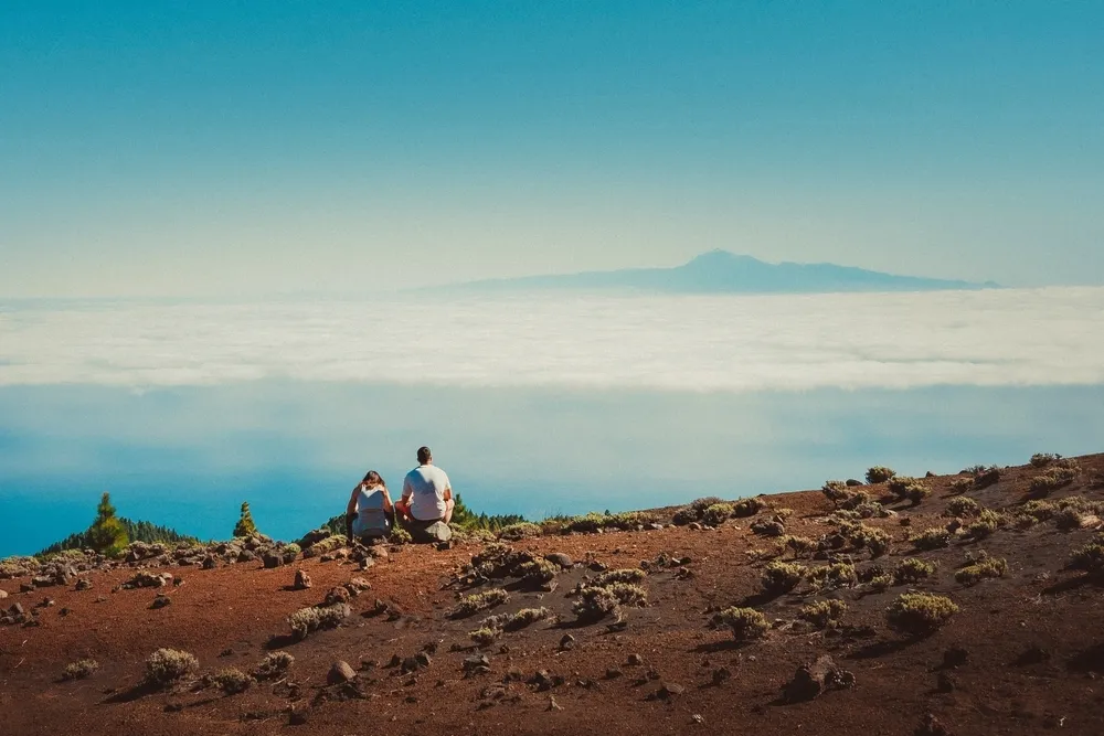 Two people look at the view from Ruta De Los Volcanes, La Palma, Canary Islands, Spain