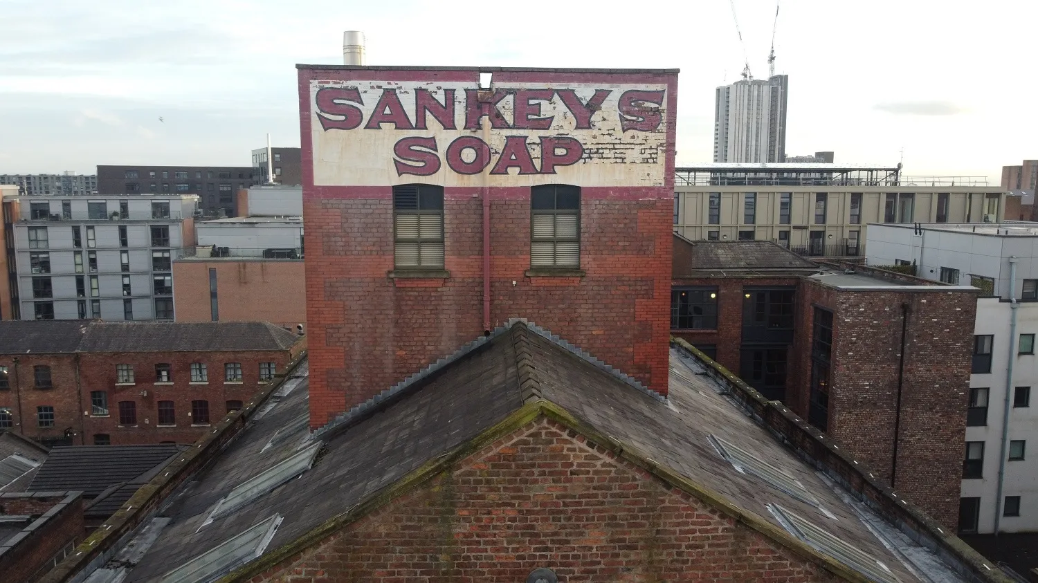 Photo of a red brick industrial building in Manchester with a sign that says 'Sankeys Soap'