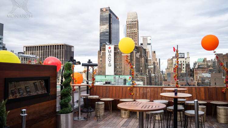 An outdoor rooftop bar overlooking the Macy's building 