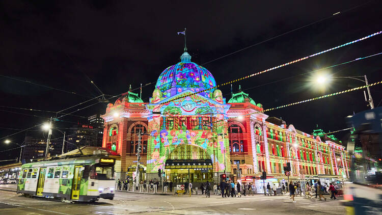 Flinders Street Station at night illuminated by Christmas lights.