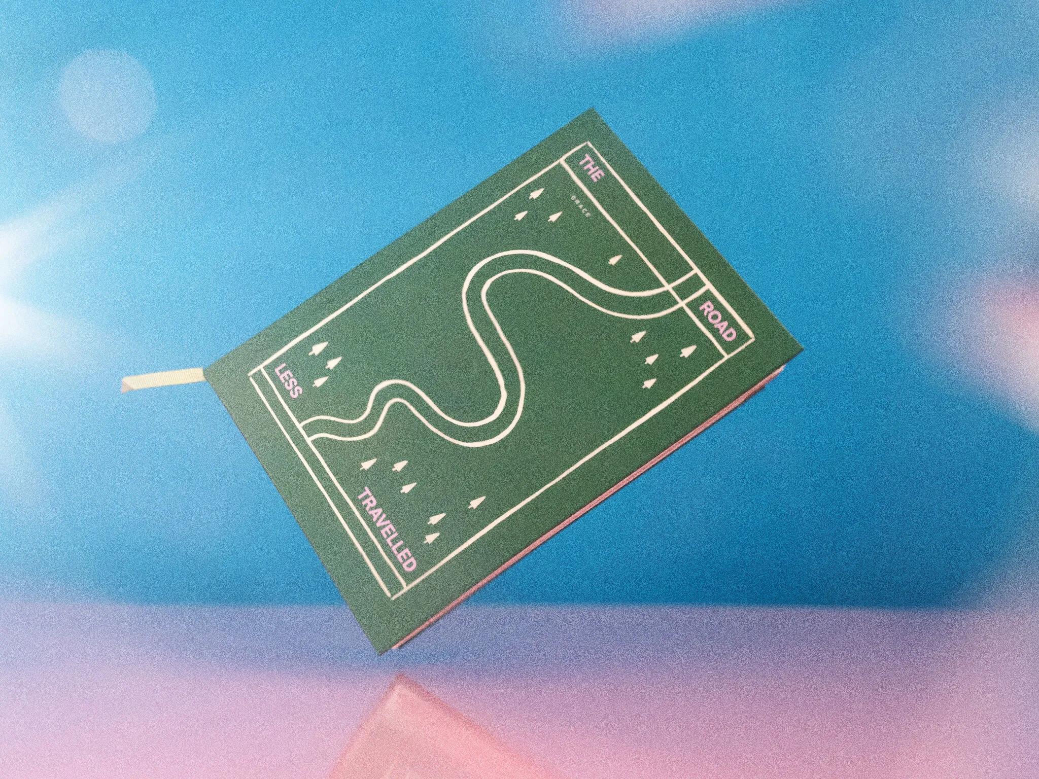 Papier travel journal against a blue and pink background