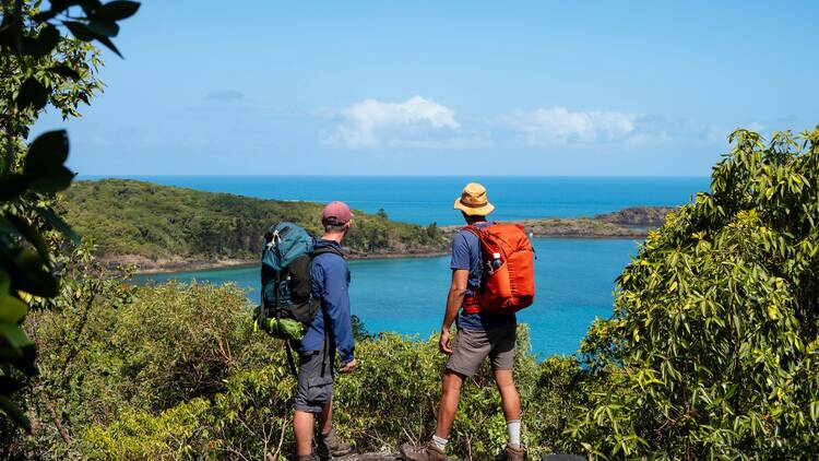 Hikers looking out over beach