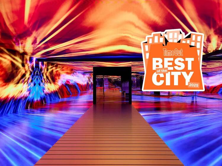 Colorful displays are projected on a wall at an immersive exhibit. Colorful displays are projected on a wall at an immersive exhibit.