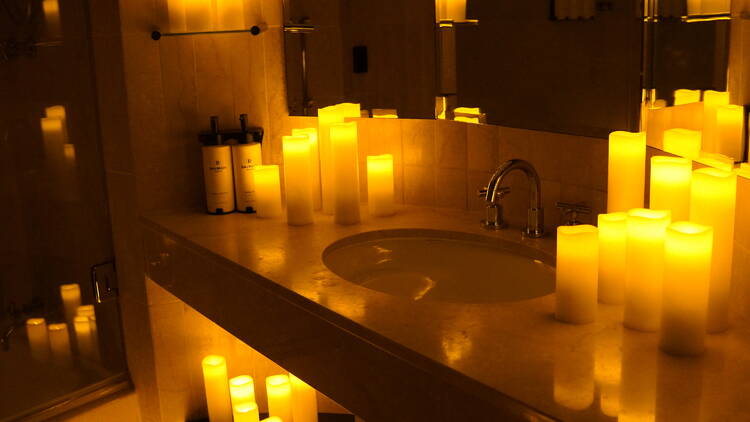 Sofitel Sydney Wentworth - Candle Experience Candles dotted around a dark bathroom