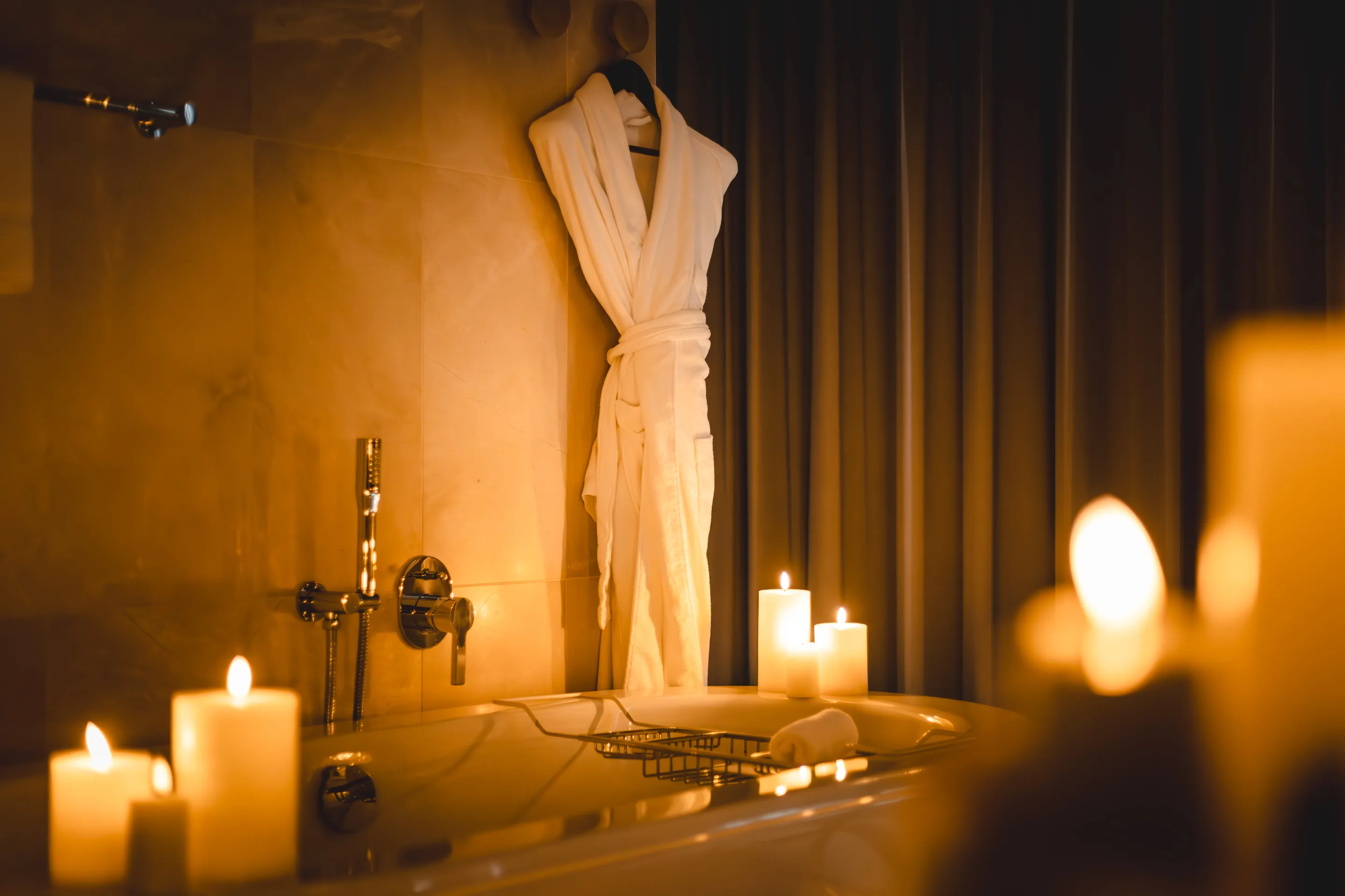 Candles surrounding a bath in a hotel room