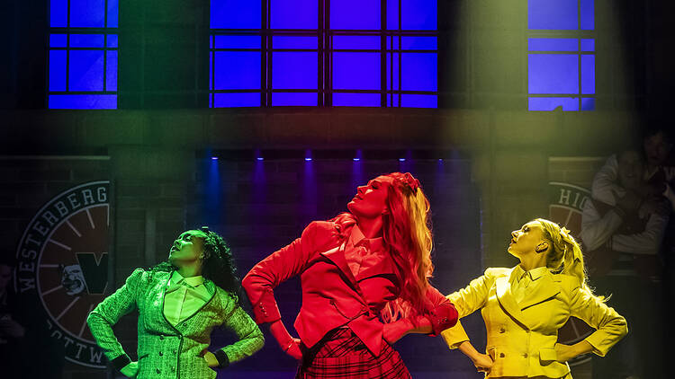 Three women strutting in lights dancing on stage Three women strutting in lights dancing on stage