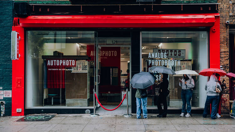 People wait in line outside of AUTOPHOTO, an analog photobooth museum. People wait in line outside of AUTOPHOTO, an analog photobooth museum.