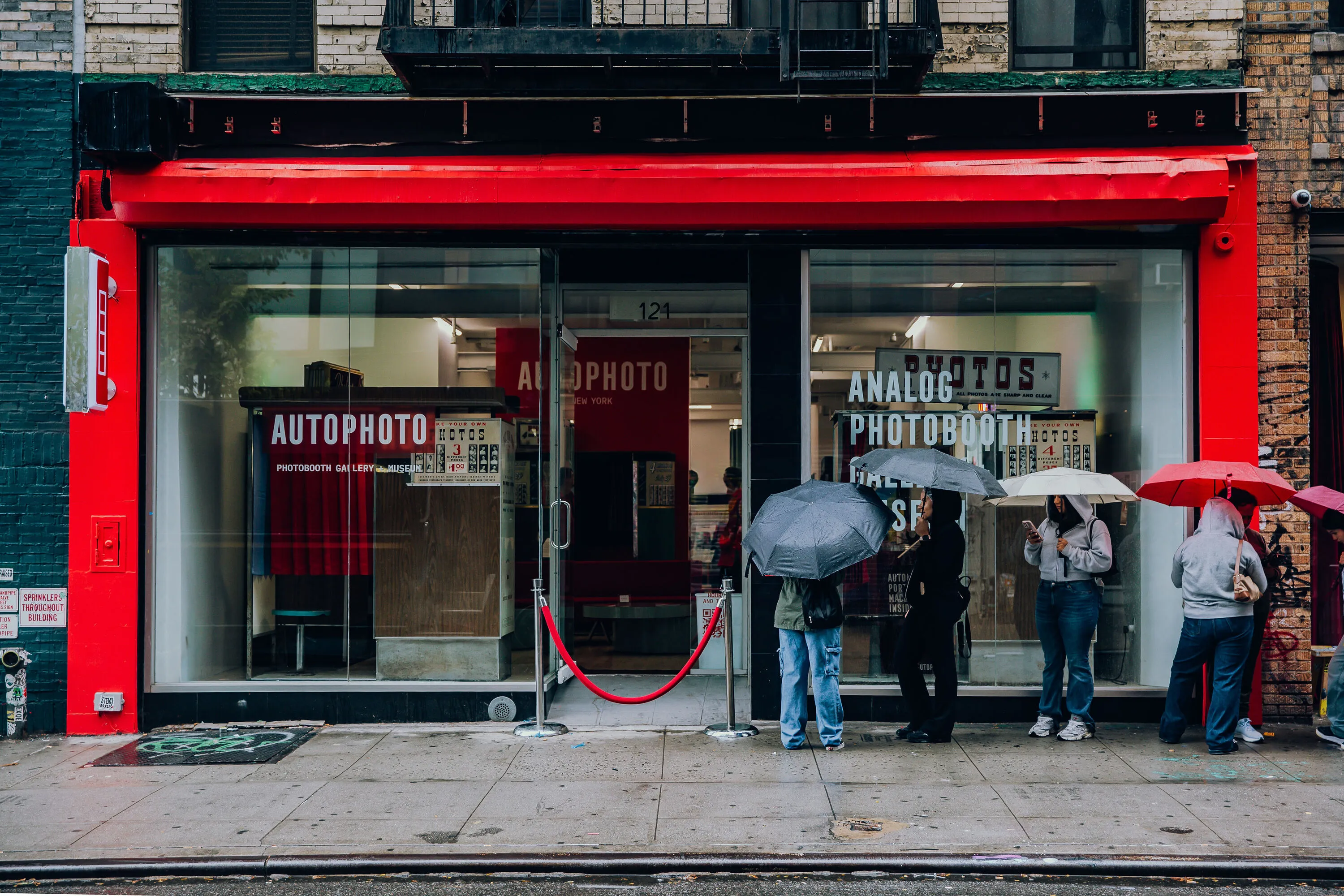 People wait in line outside of AUTOPHOTO, an analog photobooth museum.