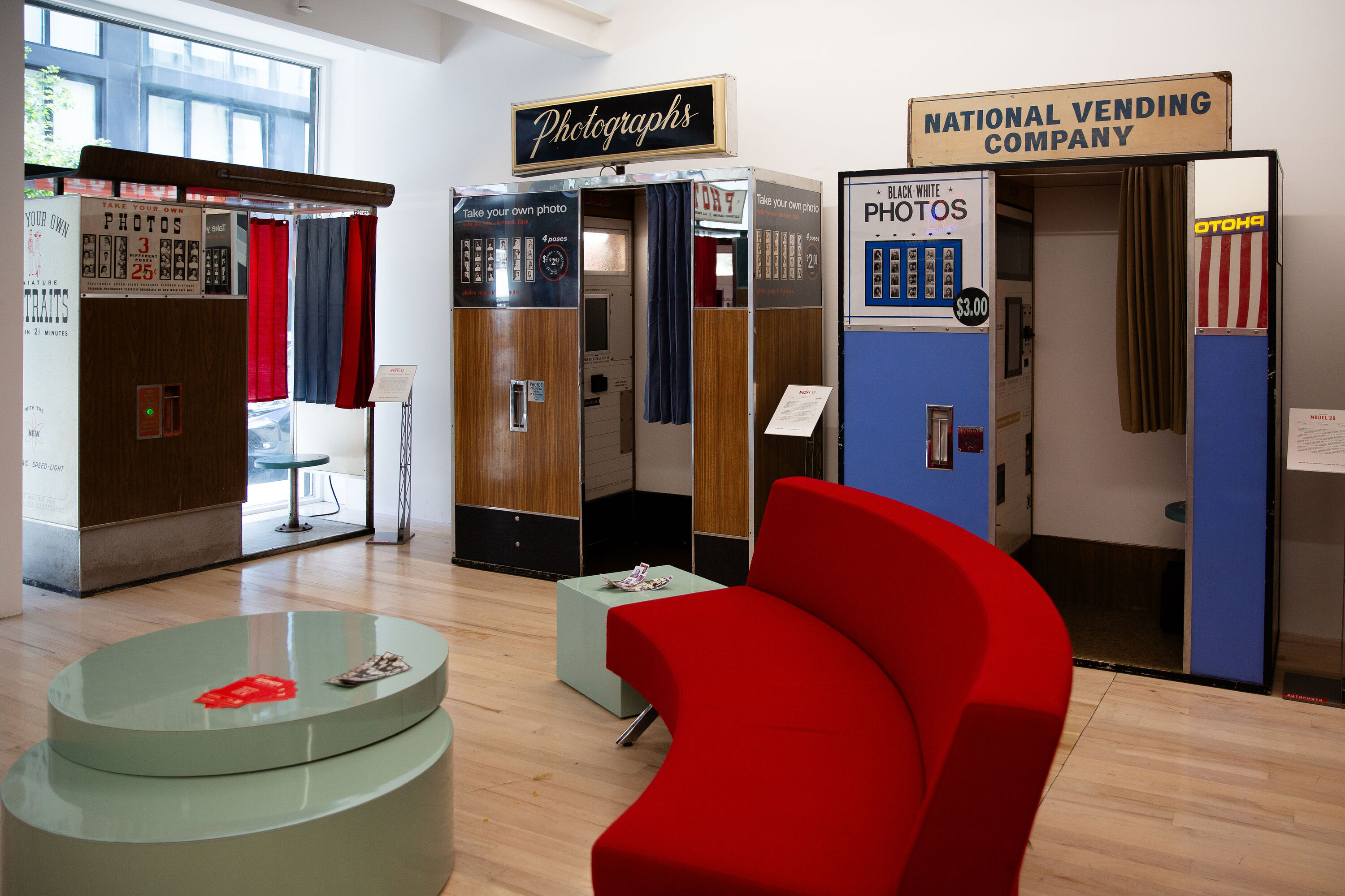 A collection of vintage photobooths inside of a museum.
