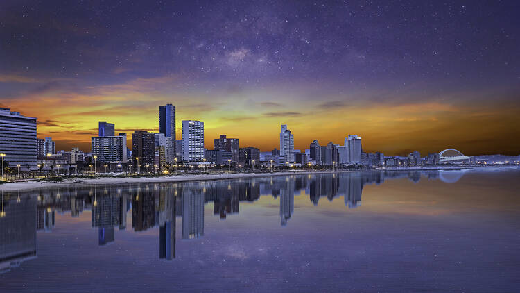 Durban city beachfront after sunset with colourful clouds and stars in the sky 1254213905
