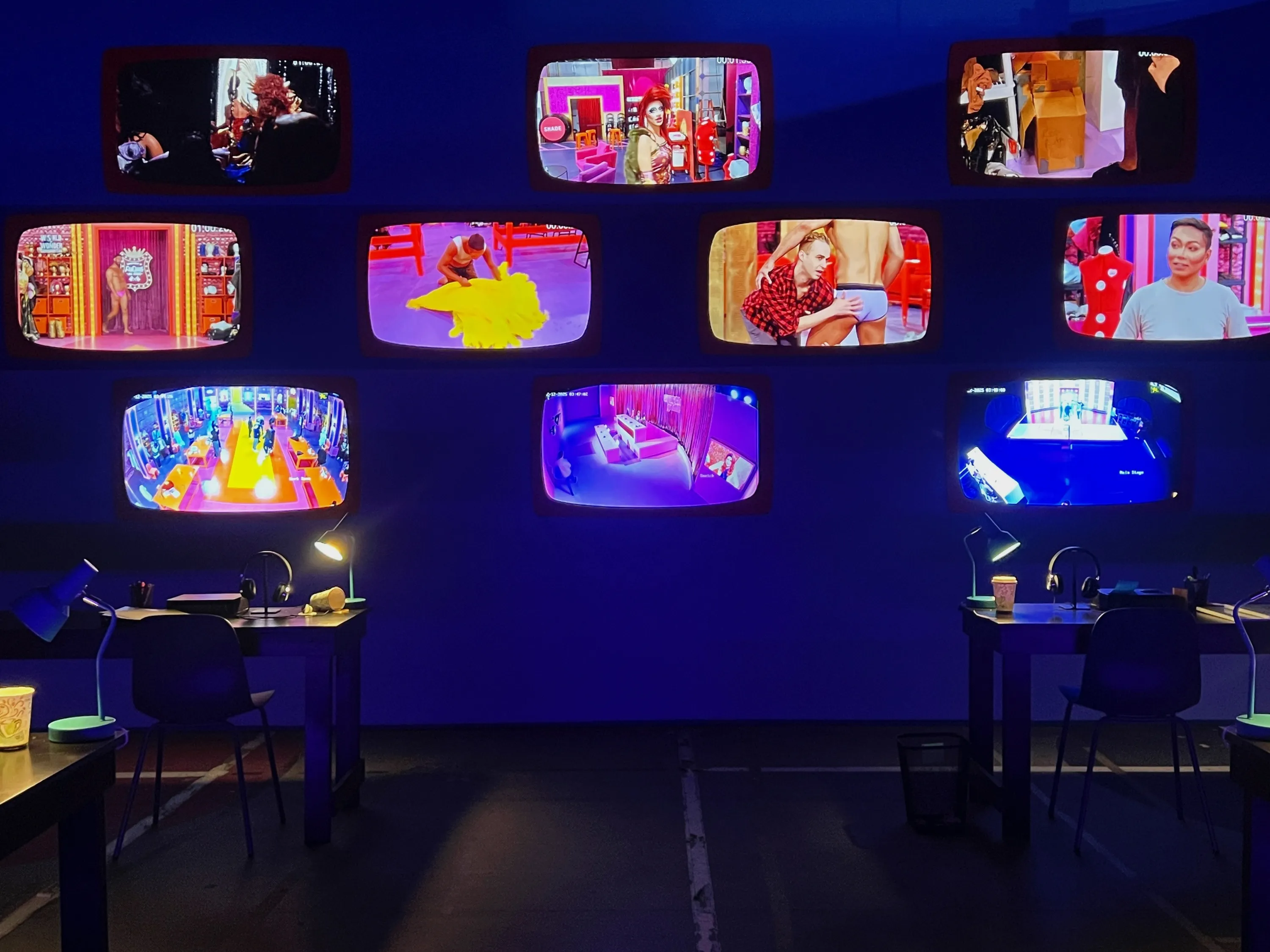 Behind-the-scenes footage playing on retro television screens in the "Drag Race: The Experience" installation in Logan Square, Chicago.