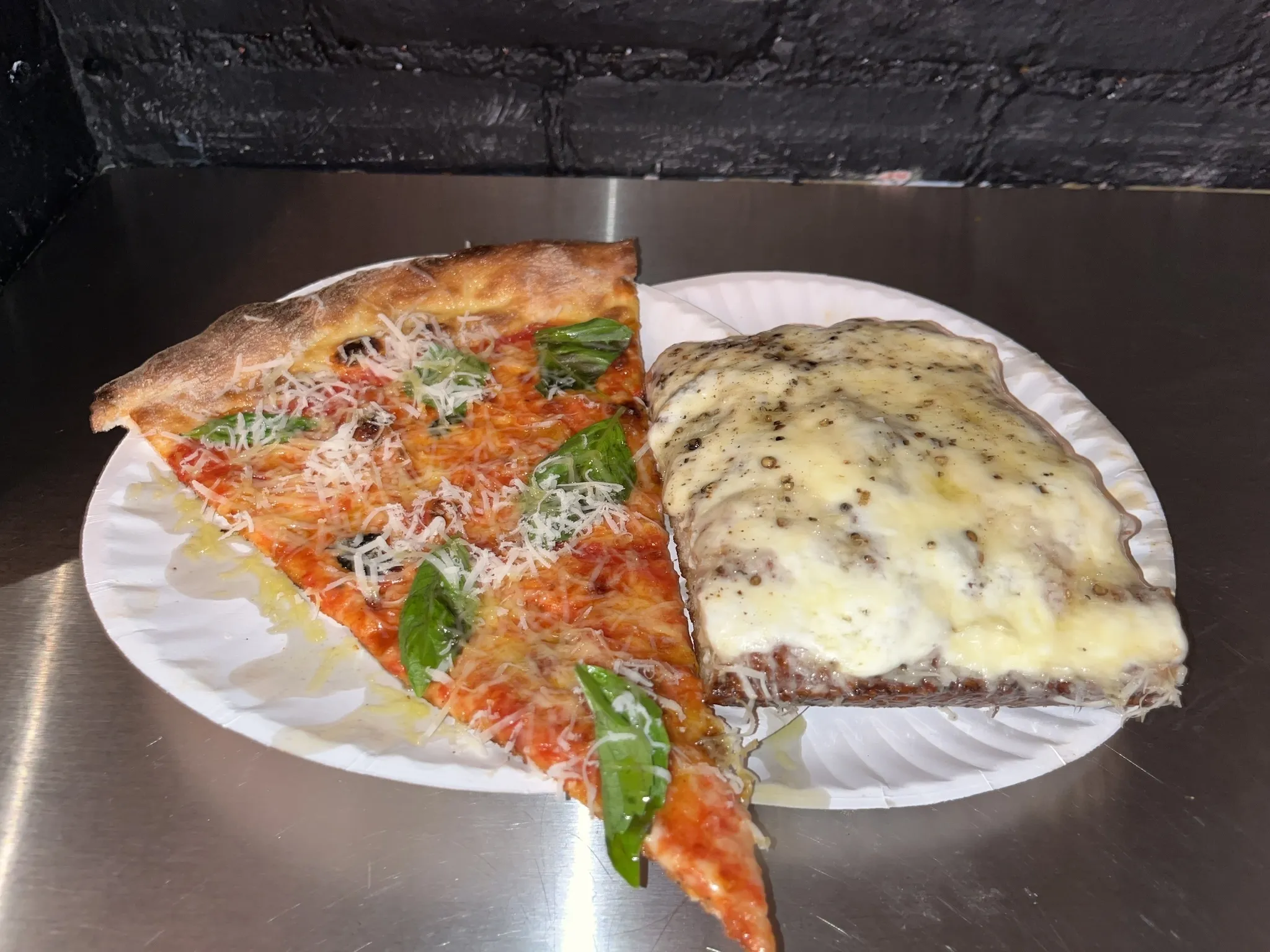 Two slices on two paper plates