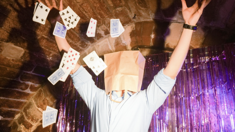 person throwing cards in the air