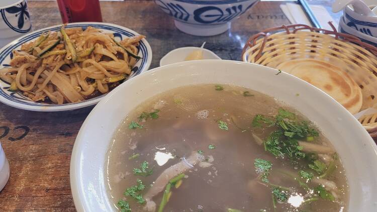 A bowl of soup and noodles