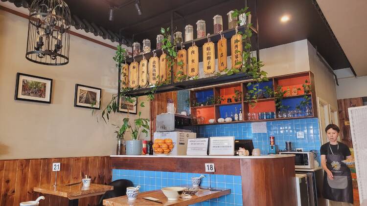 A Chinese restaurant with lampshades and pot plants
