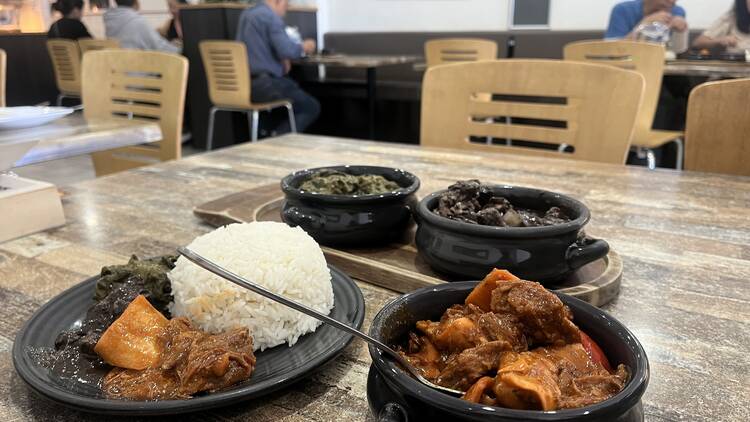 The Kamayan - Filipino Stews and rice on a table