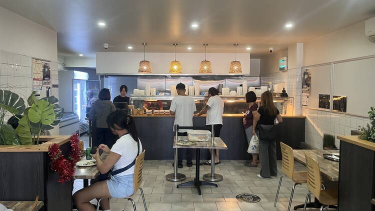The Kamayan - Filipino People lining up at a counter to order food
