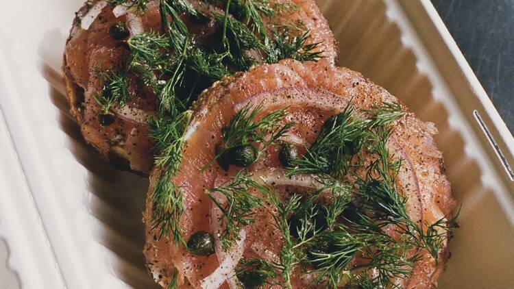 Apollo Bagels A bagel with smoked salmon, cream cheese and capers in a takeout container