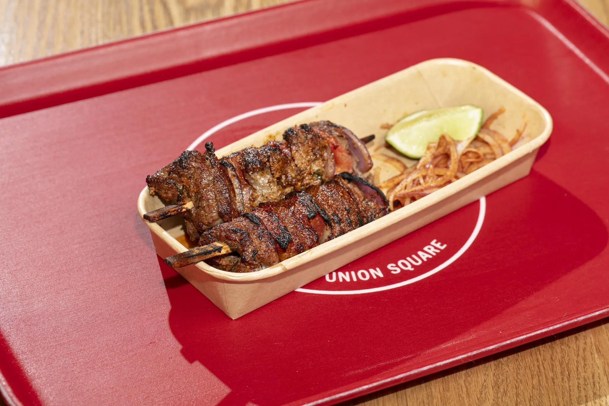 A kebab on a red tray 
