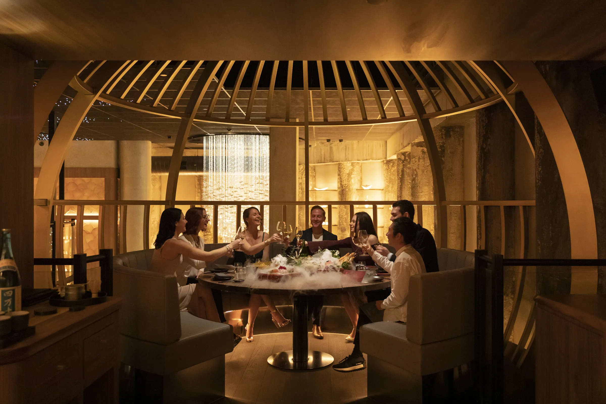 Guests toasting to the new year in an exclusive dining area at Yugen.