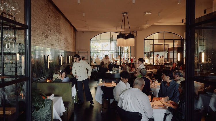 Cutler and Co Waiter serving a table in Cutler and Co's dining room.