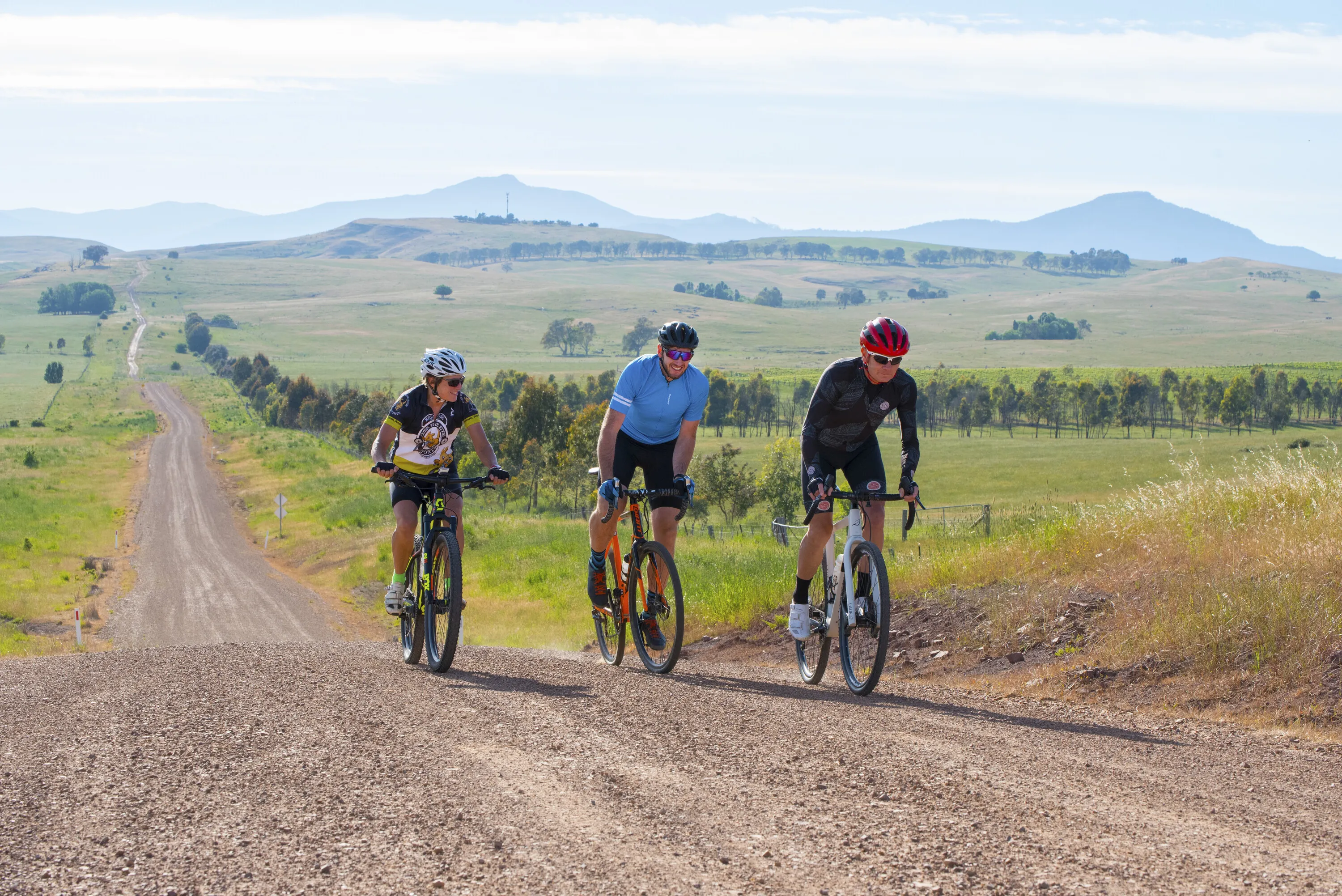 Three cyclists on country road