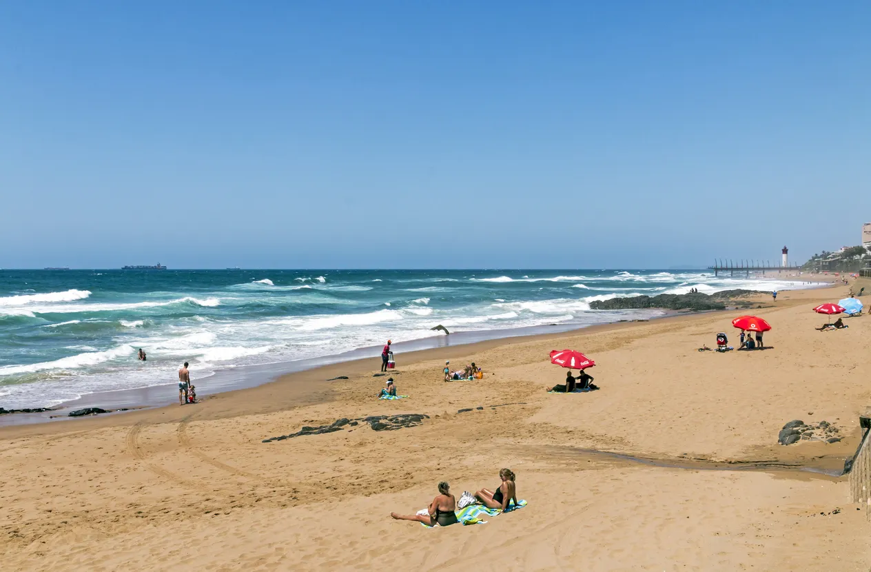  Coastal landscape of many unknown people on early morning visit to uMhlanga beach in Durban, South Africa
