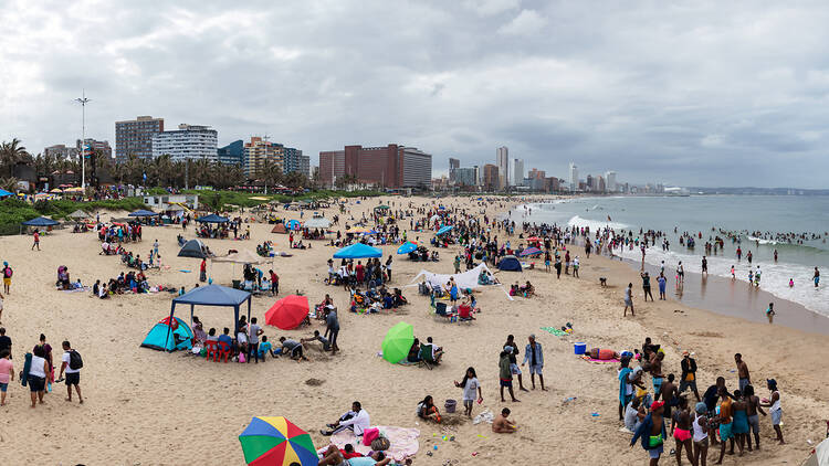 Panoramic view of the beach full of people in Durban next to the UShaka Marine World, South Africa. Panoramic view of the beach full of people in Durban next to the UShaka Marine World, South Africa.