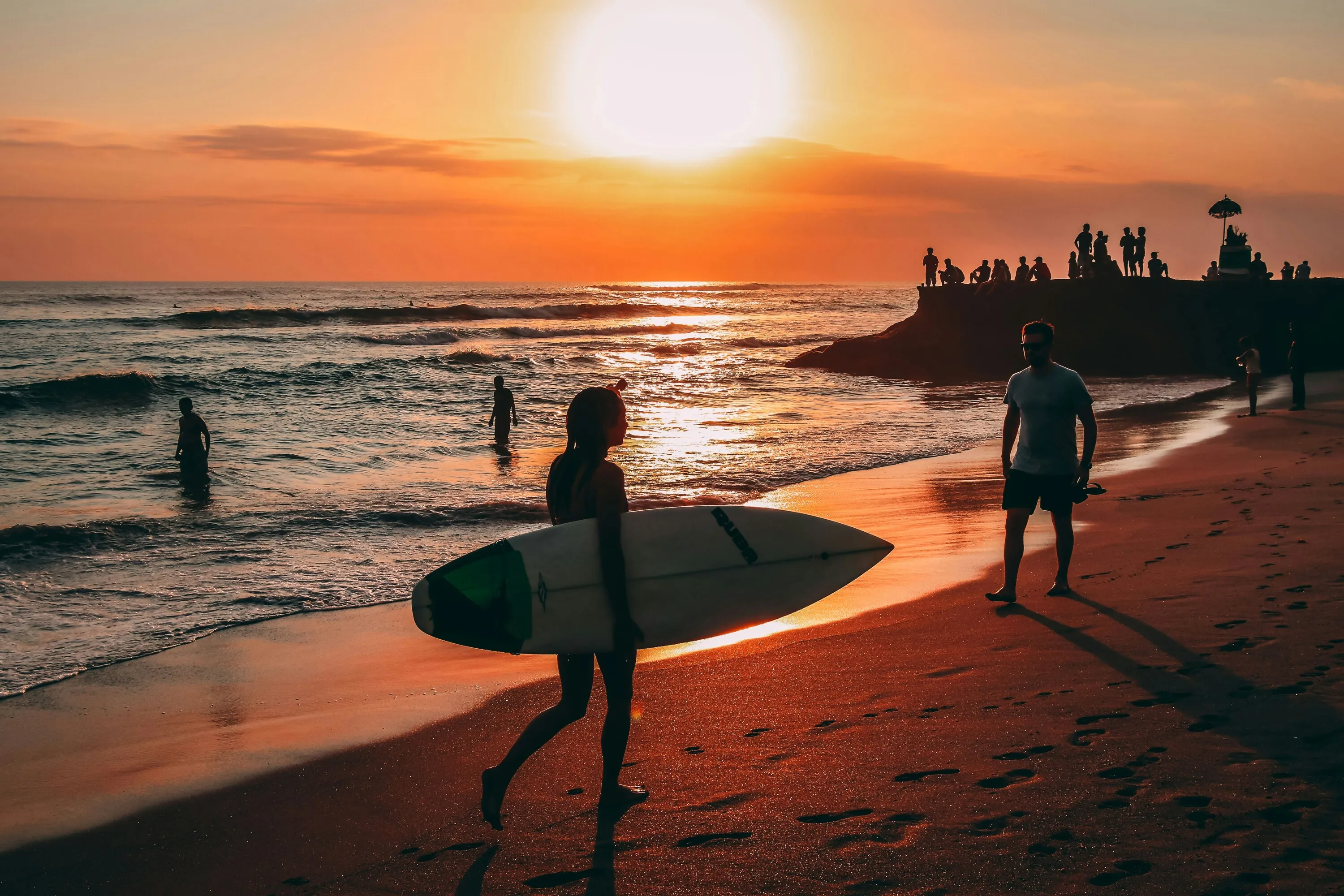 Surfers at sunset
