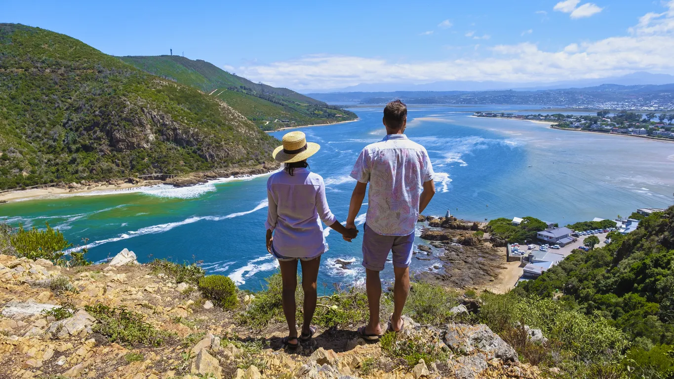 A couple of men and women on top of the hill with A panoramic view of the lagoon of Knysna, South Africa. beach in Knysna, Western Cape, South Africa.
