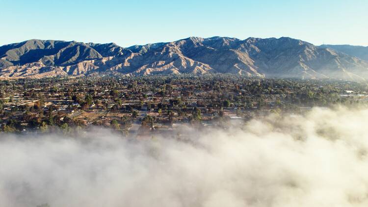 An aerial shot of smoke rolling above Altadena.