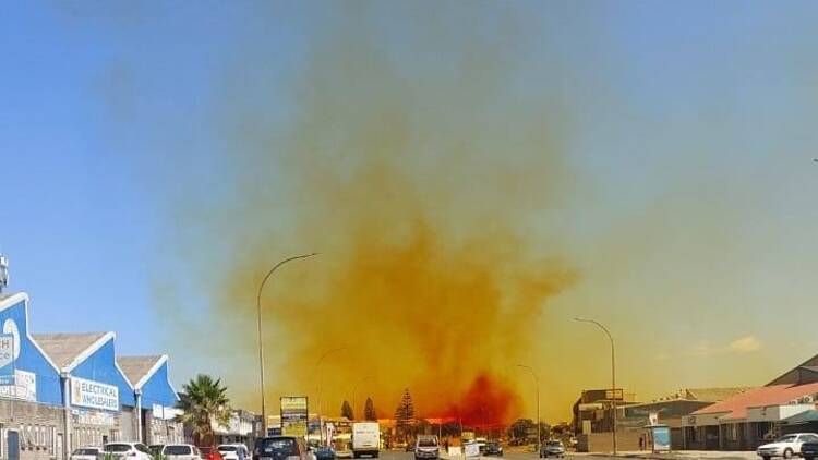 A chemical plume rises above the industrial area of Montague Gardens.