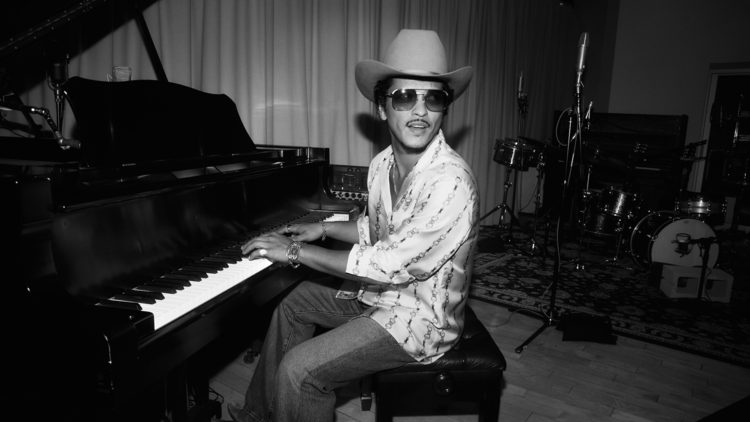Bruno Mars playing the piano.