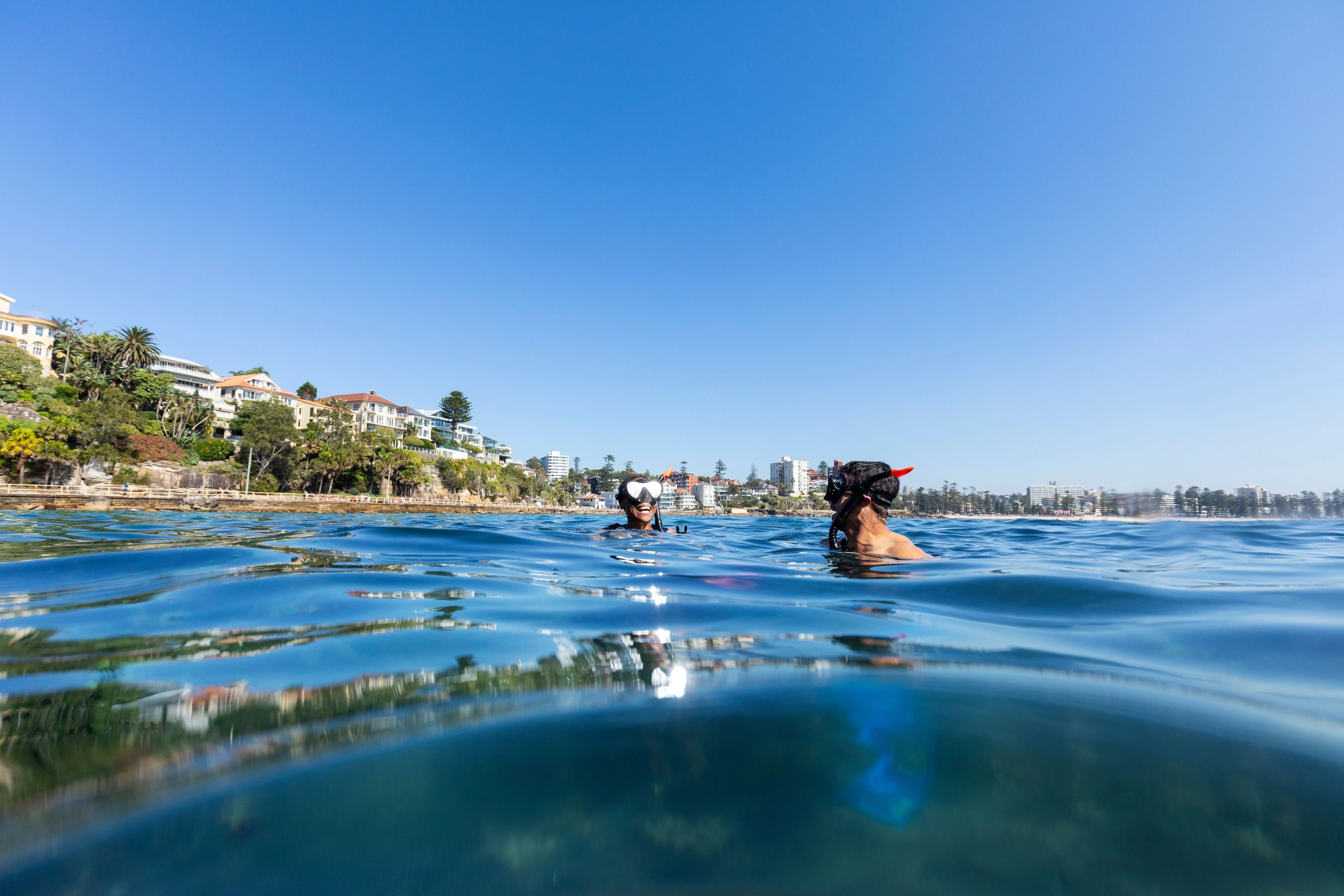 A couple enjoys the water at Shelly Beach, Manly