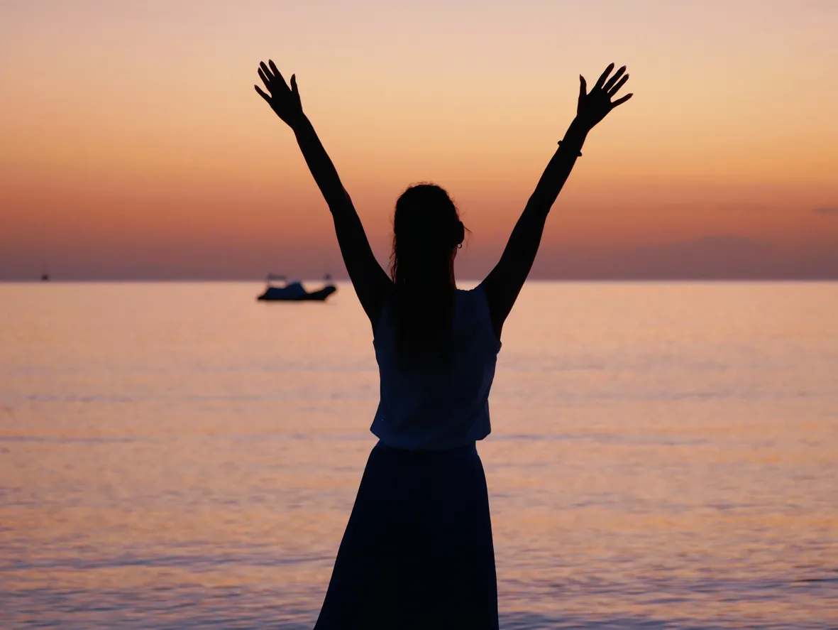 Silhouette of a woman standing on the beach 