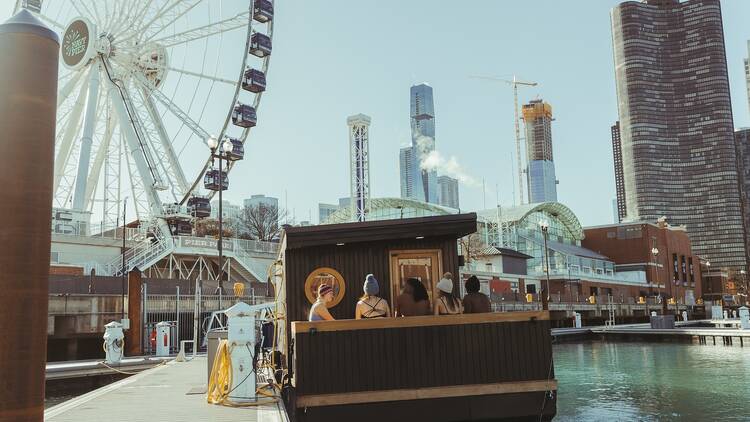 Guests bask in the cool weather at Kiln Floating Sauna.