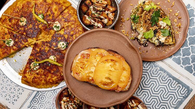 Four dishes on a blue and white tiled table