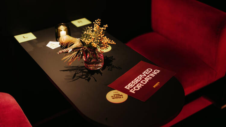 Table with flowers and sign that says 'reserved for dating’