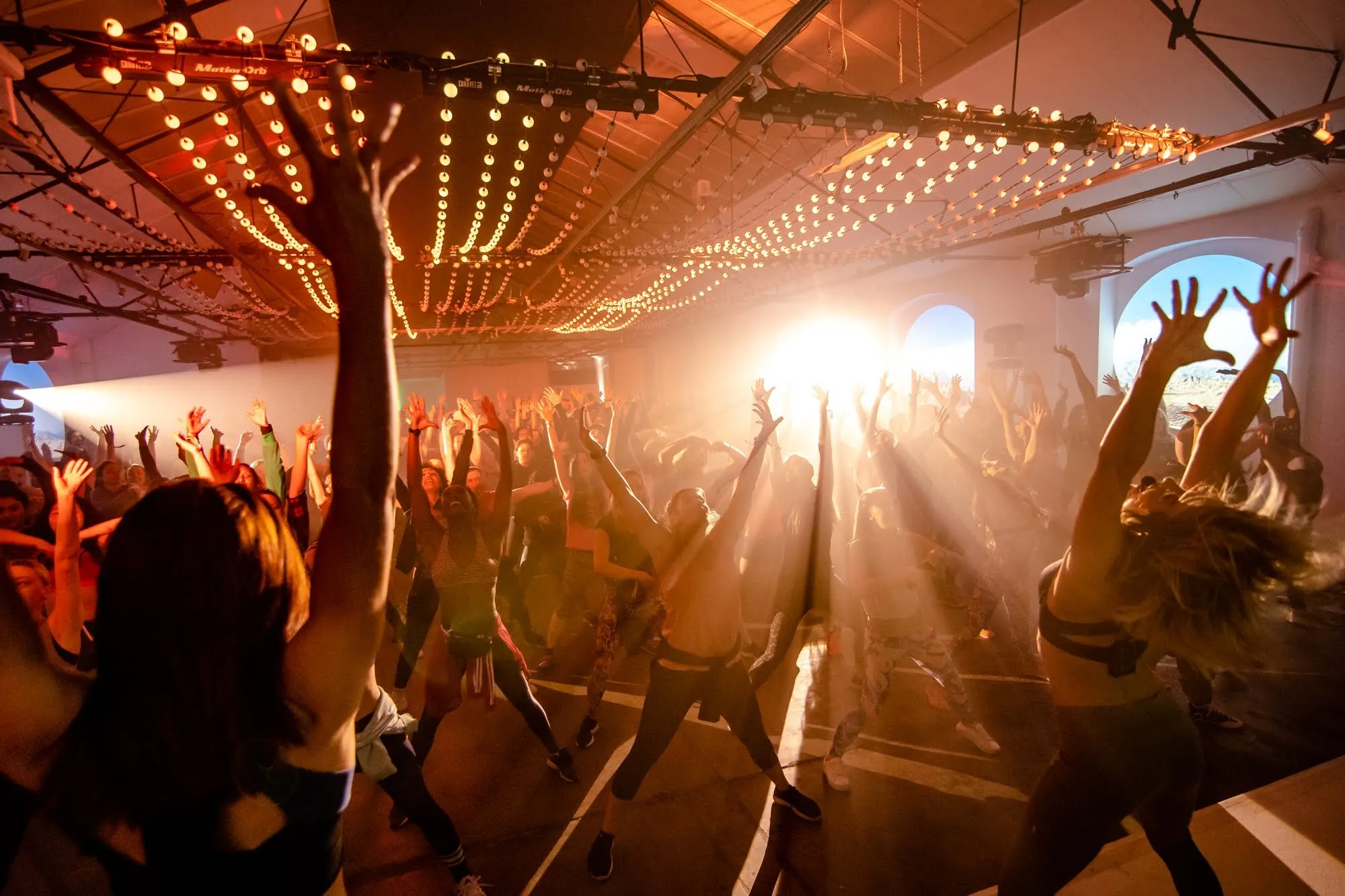People dancing at a sunrise rave.