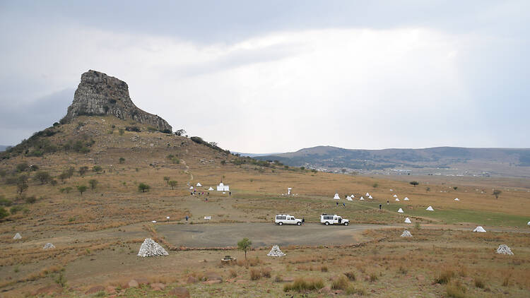 Isandlwana, South Africa. September 2018. The battlefield of Isandlwana (1879). Photo from a tour of South Africa. The white cairns mark where human remains were found after the battle.