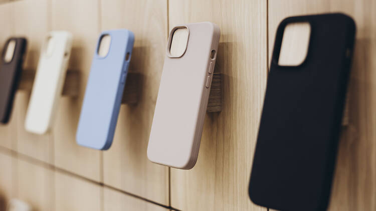 2190225229 Assortment of protective cellphone phone cases in electronics shop interior. Colorful phone cases hanging in the phone store. Different mobile phone cases on shelves in a multimedia store.