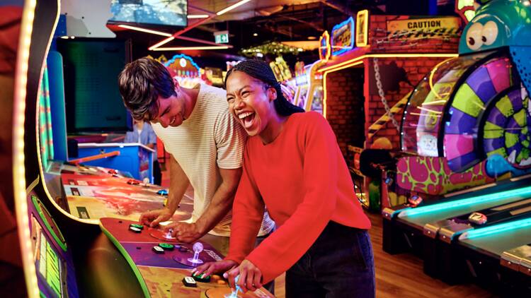 Zone Couple playing at an arcade