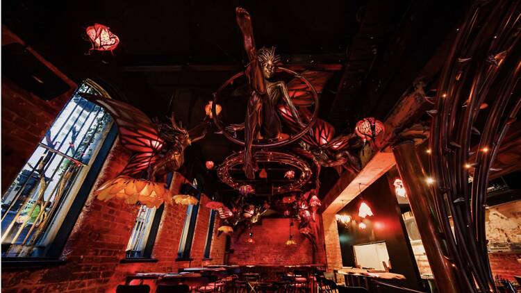 Inside a red, fairy-themed bar. 