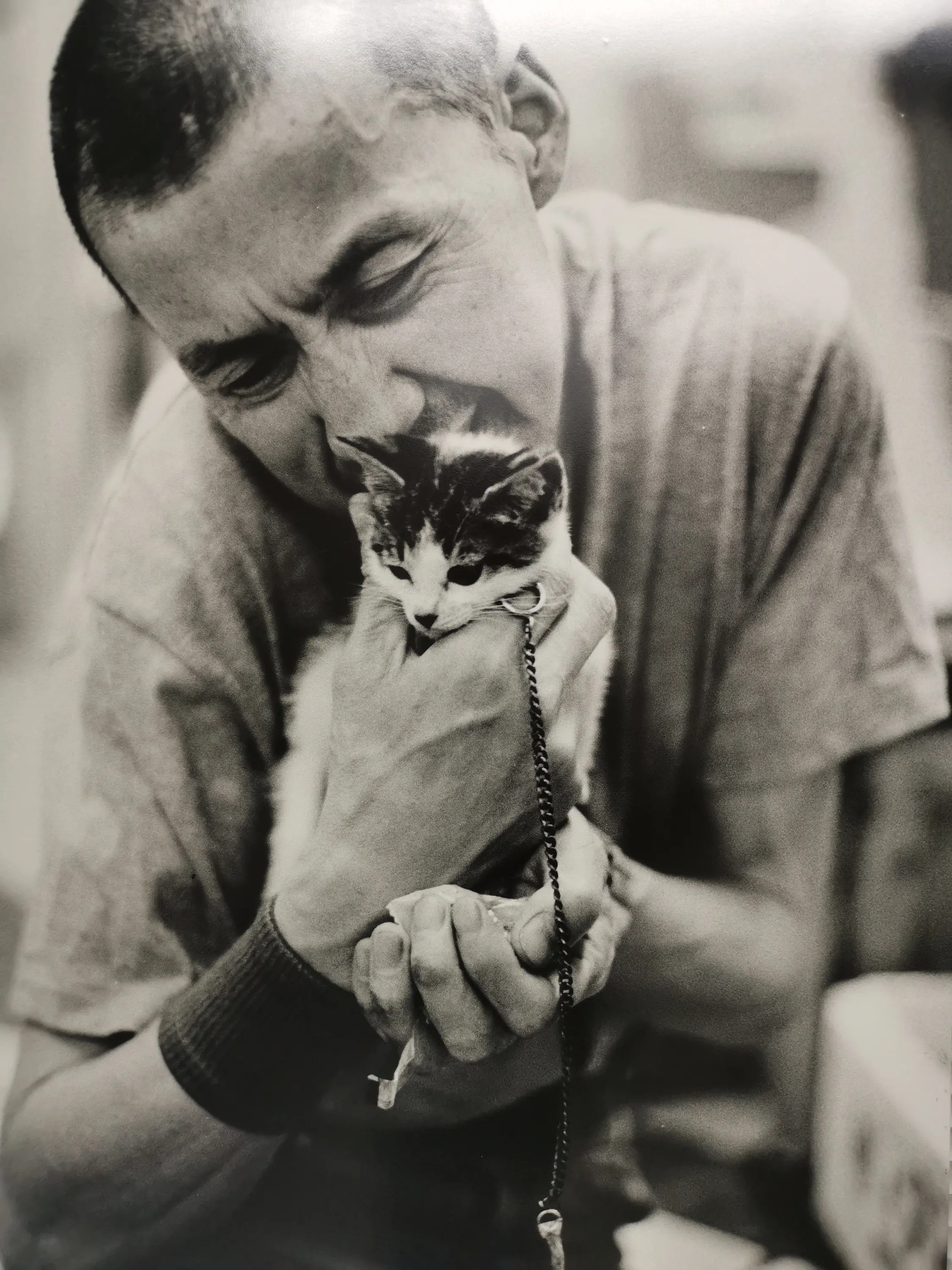 Crying man holding kitten