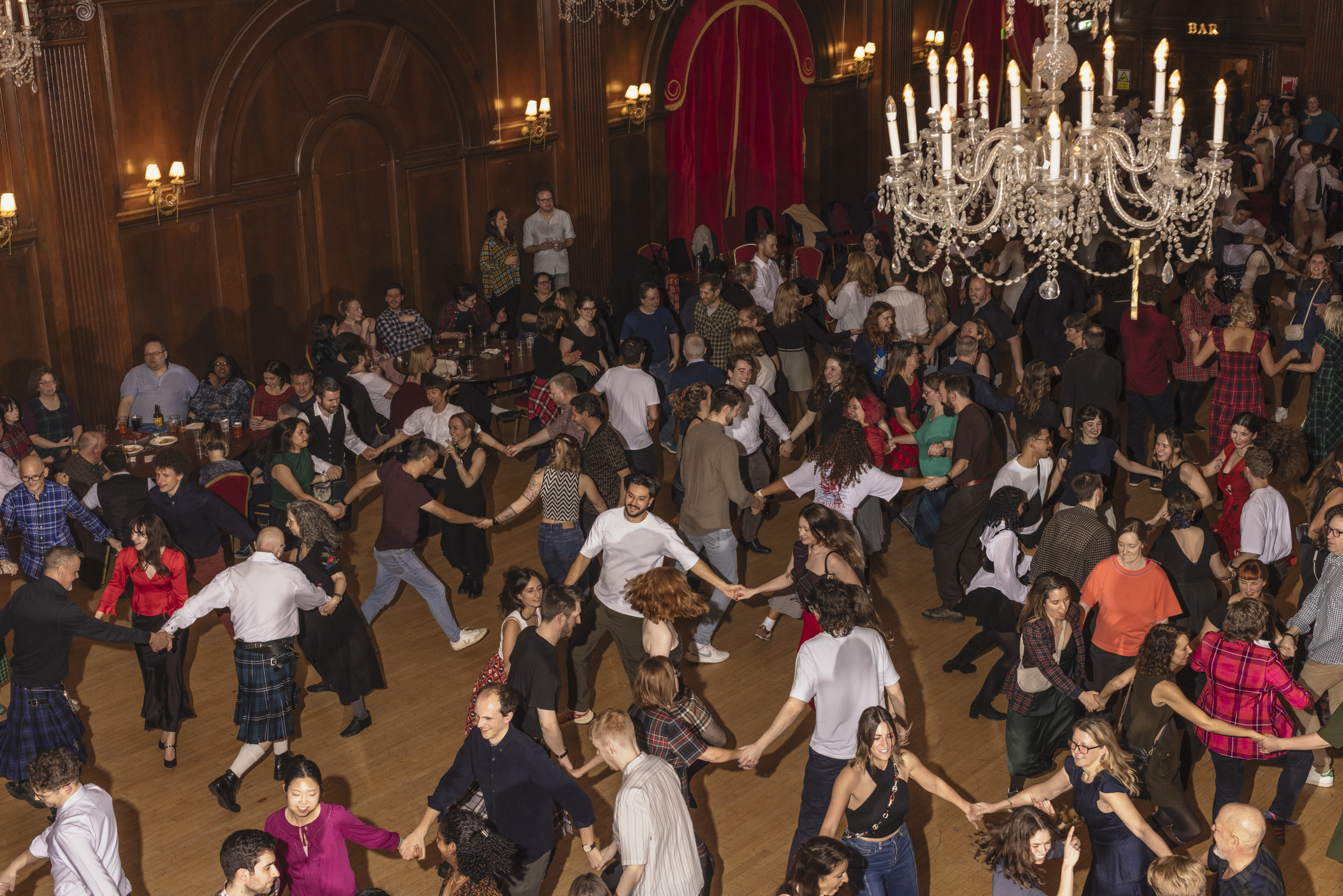 People dancing at a ceilidh at the grand Porchester Hall 