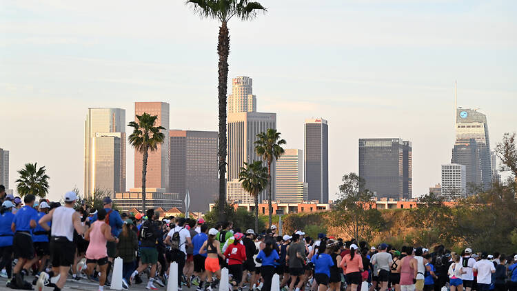 Runners against a backdrop of palm trees and the L.A. skyline.