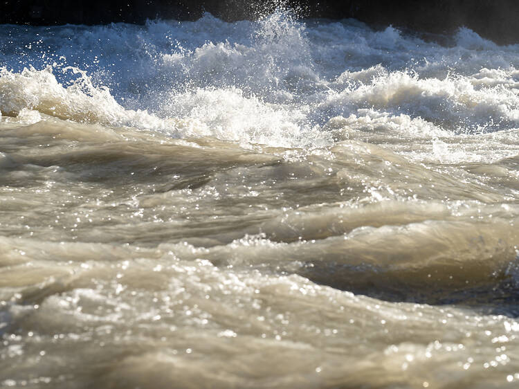 Determined travellers walk through floodwaters at OR Tambo not to miss flight
