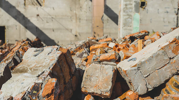 Demolition of an old building. Fragments of brick. Industrial background 1386819392 Demolition of an old building. Fragments of brick. Industrial background