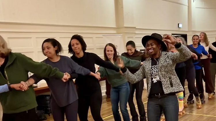 A group enjoys a roller dance class at Chicago Athletic Association.