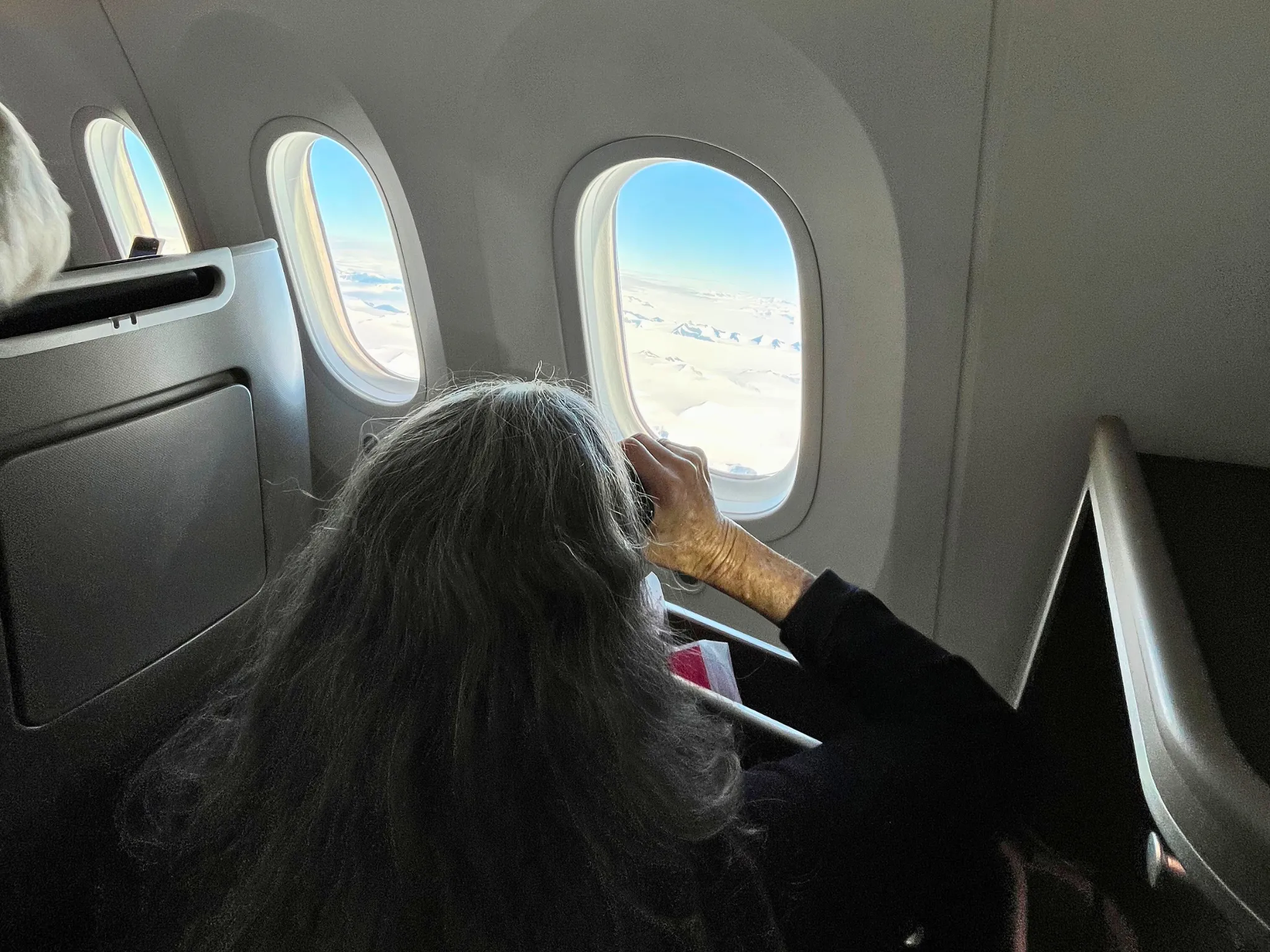 Person looking out plane window